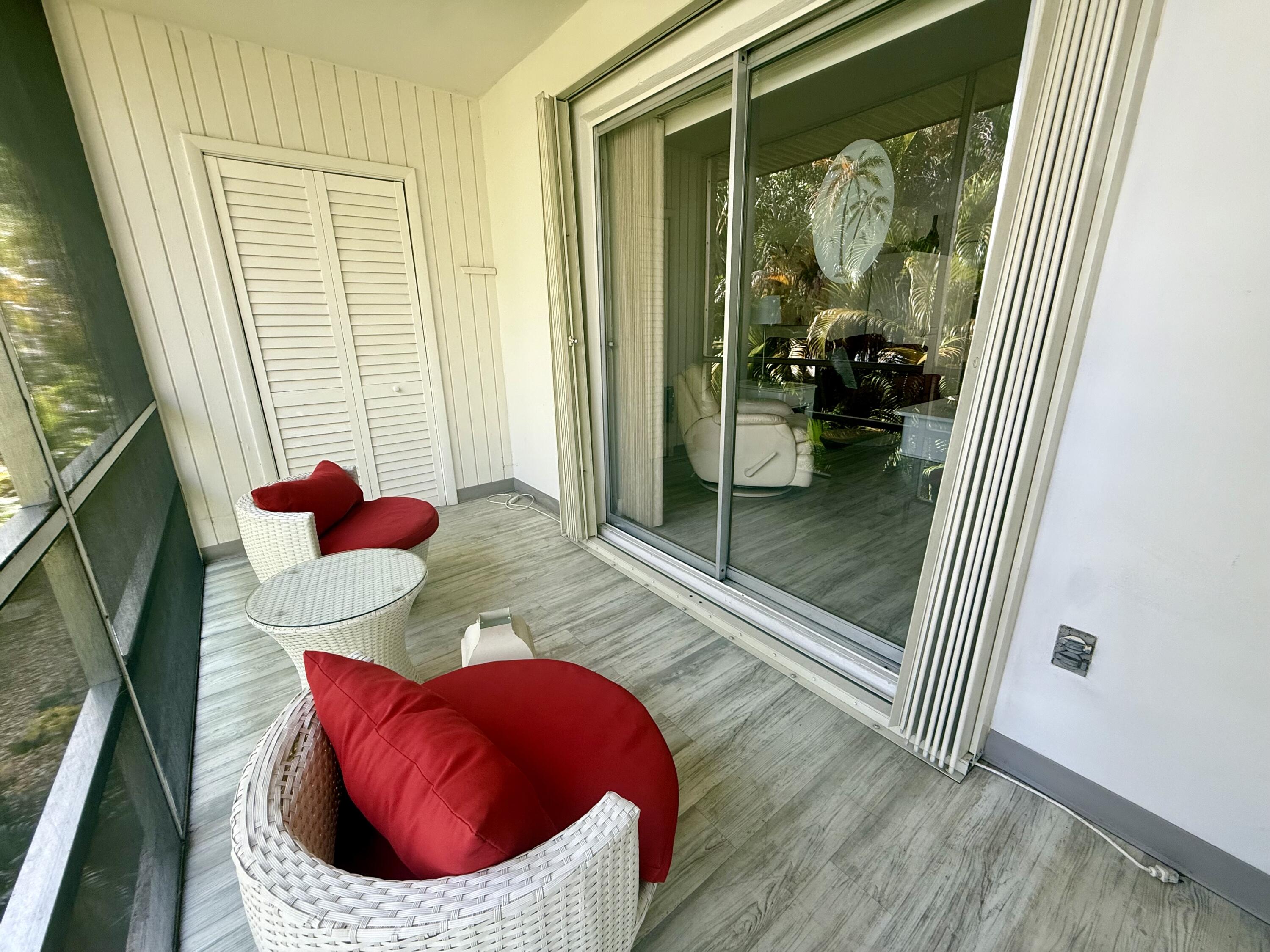 1982 Southwest Palm City Road, Unit F Stuart, FL 34994 - Photo 21 of 34 a living room with furniture and a floor to ceiling window