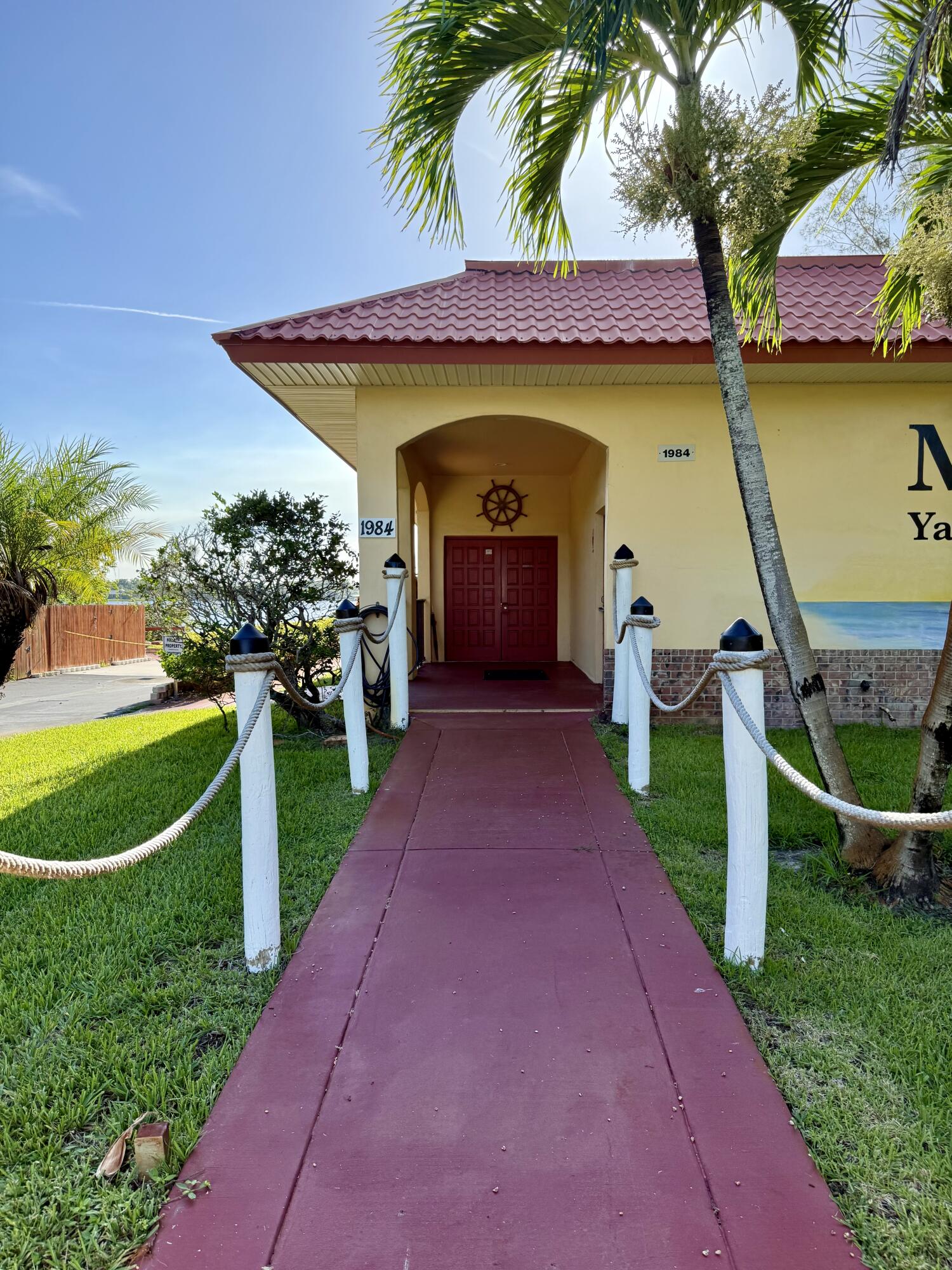 1982 Southwest Palm City Road, Unit F Stuart, FL 34994 - Photo 24 of 34 a front view of a house with a yard