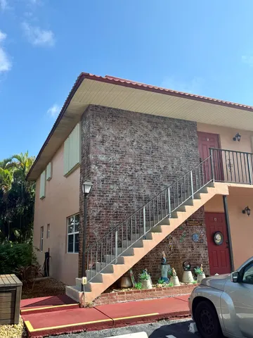 a view of a balcony with couches and wooden floor