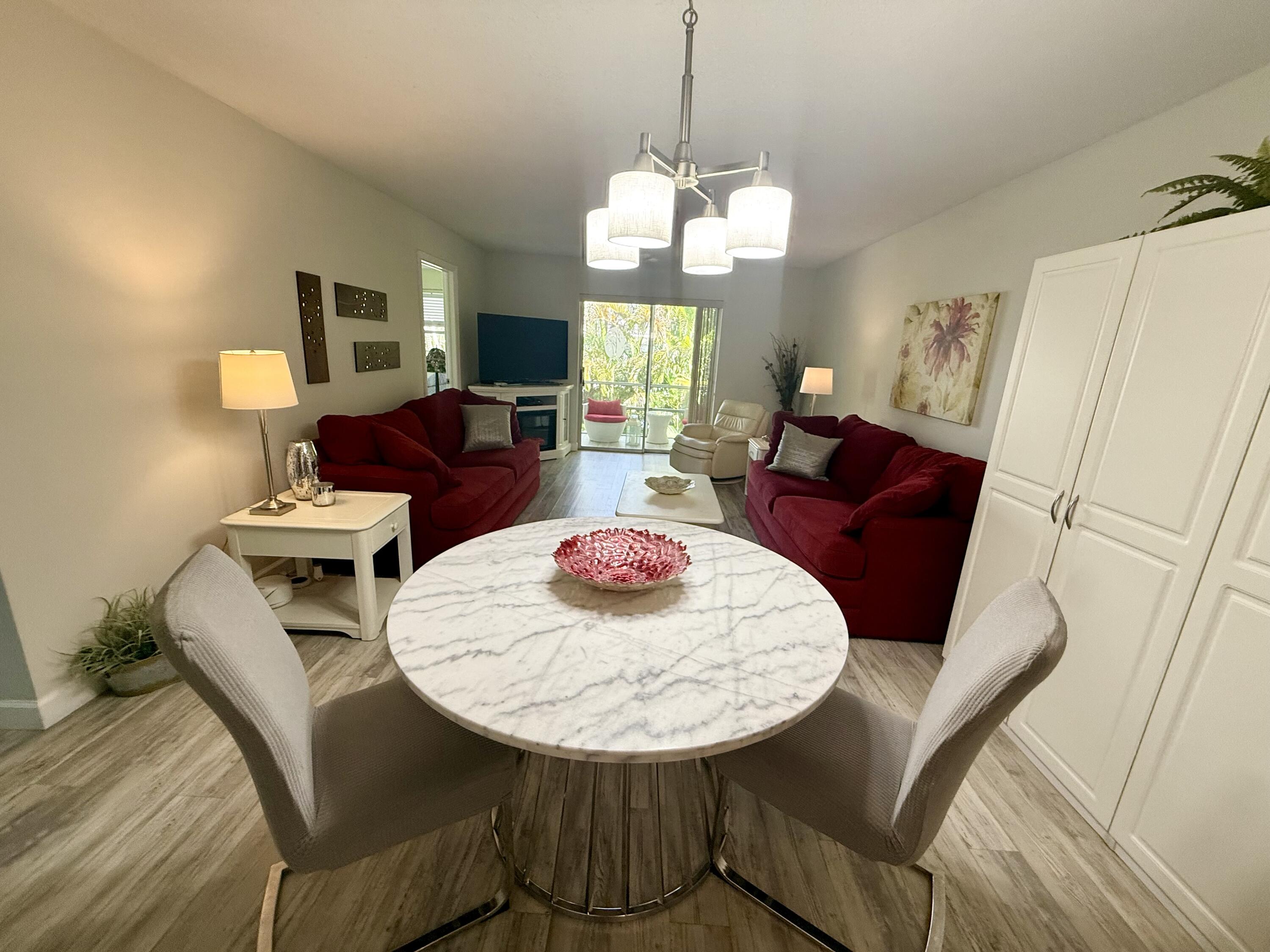 1982 Southwest Palm City Road, Unit F Stuart, FL 34994 - Photo 6 of 34 a view of a dining room with furniture and wooden floor