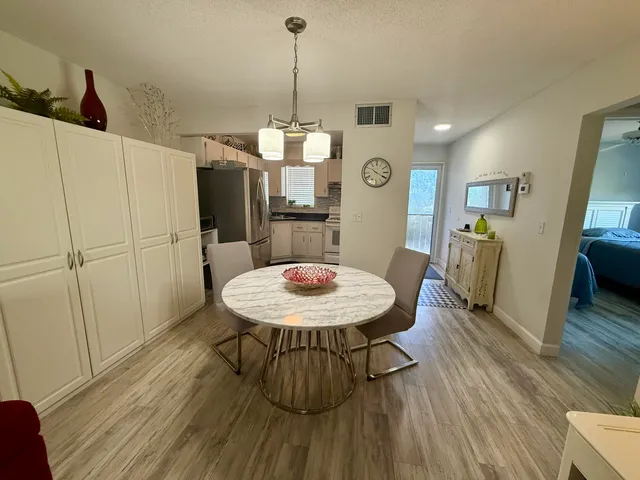 a view of a dining room with furniture and wooden floor