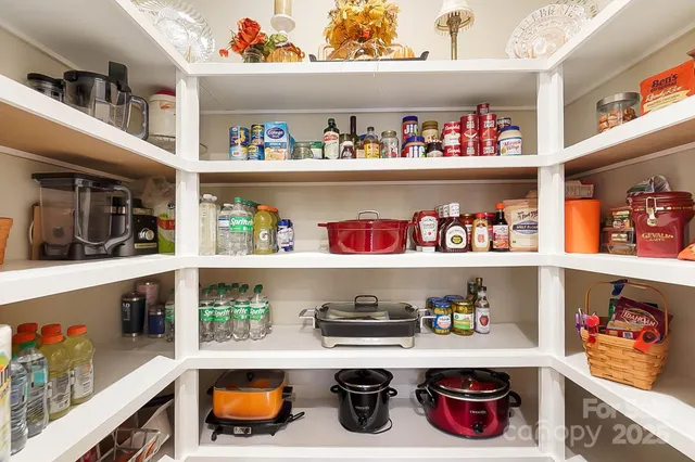 a cabinet with granite countertop lots of different kinds of food