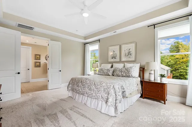 a bedroom with a large bed and a chandelier