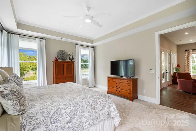 a bedroom with a balcony a bed and a television