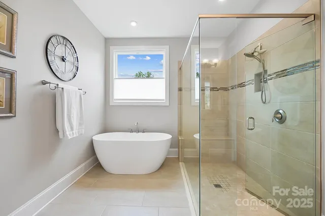 a bathroom with a toilet a sink a mirror and shower