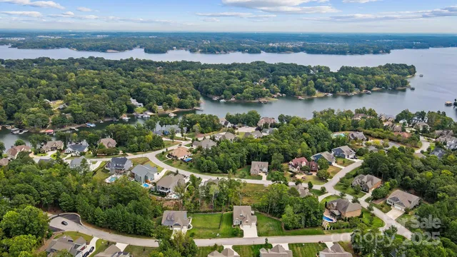 an aerial view of a city with lots of residential buildings lake and ocean view