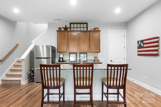 a view of a dining room that has a table chairs and a wooden floor
