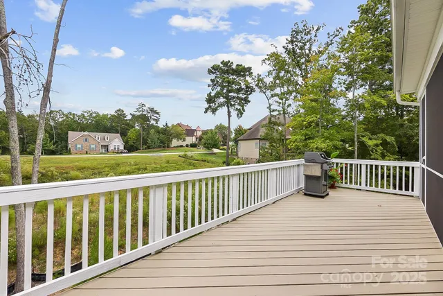 a view of balcony with wooden floor and fence