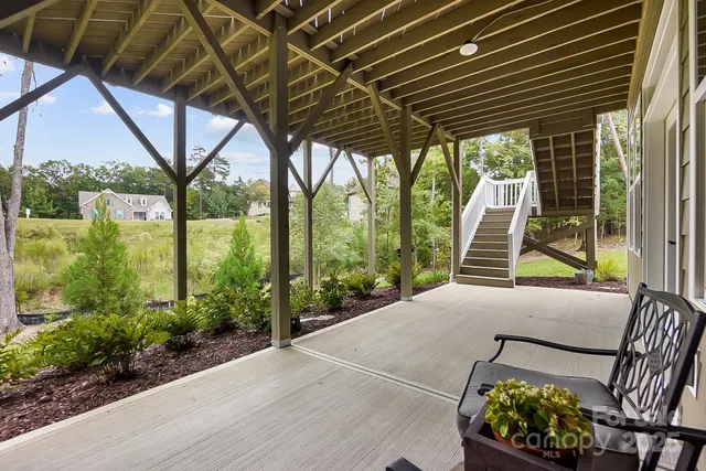 a patio with glass top table and chairs