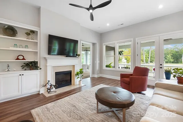 a living room with furniture a flat screen tv and a fireplace