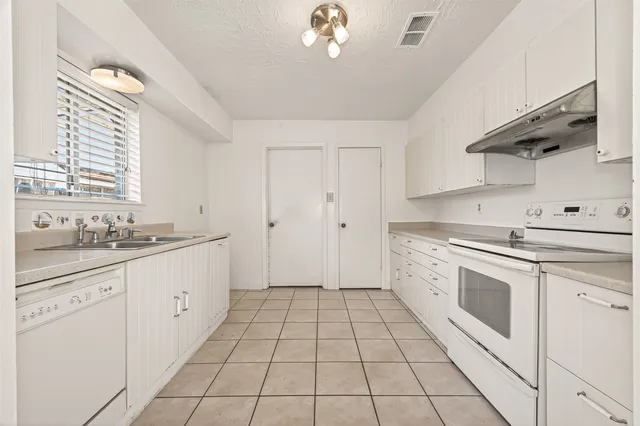 a kitchen with a sink cabinets and window