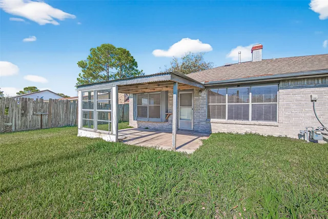 a view of a house with a yard and sitting area