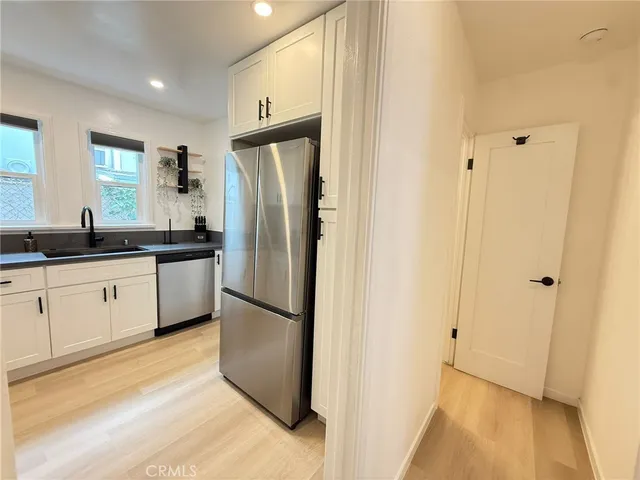 a kitchen with a refrigerator and a sink
