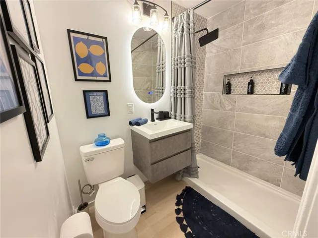 a bathroom with a toilet a sink and bathtub