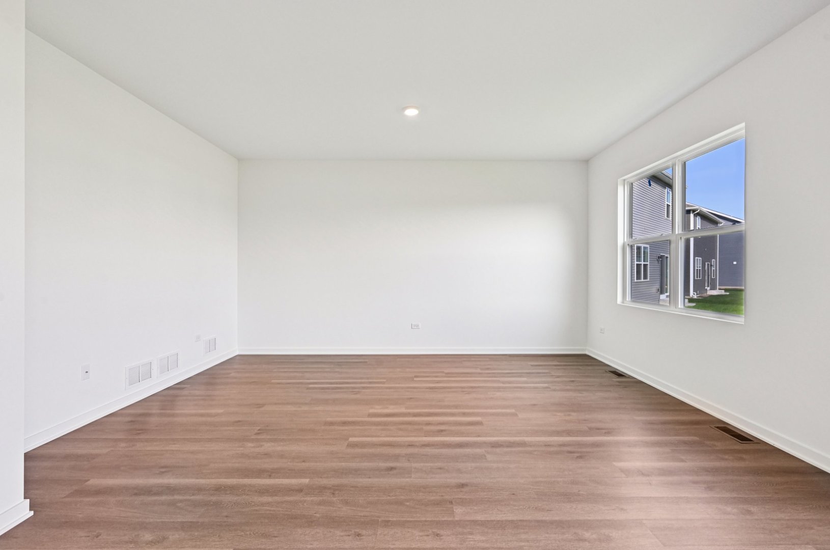 6722 Applegate Drive Plainfield, IL 60586 - Photo 17 of 45 a view of an empty room with wooden floor and a window