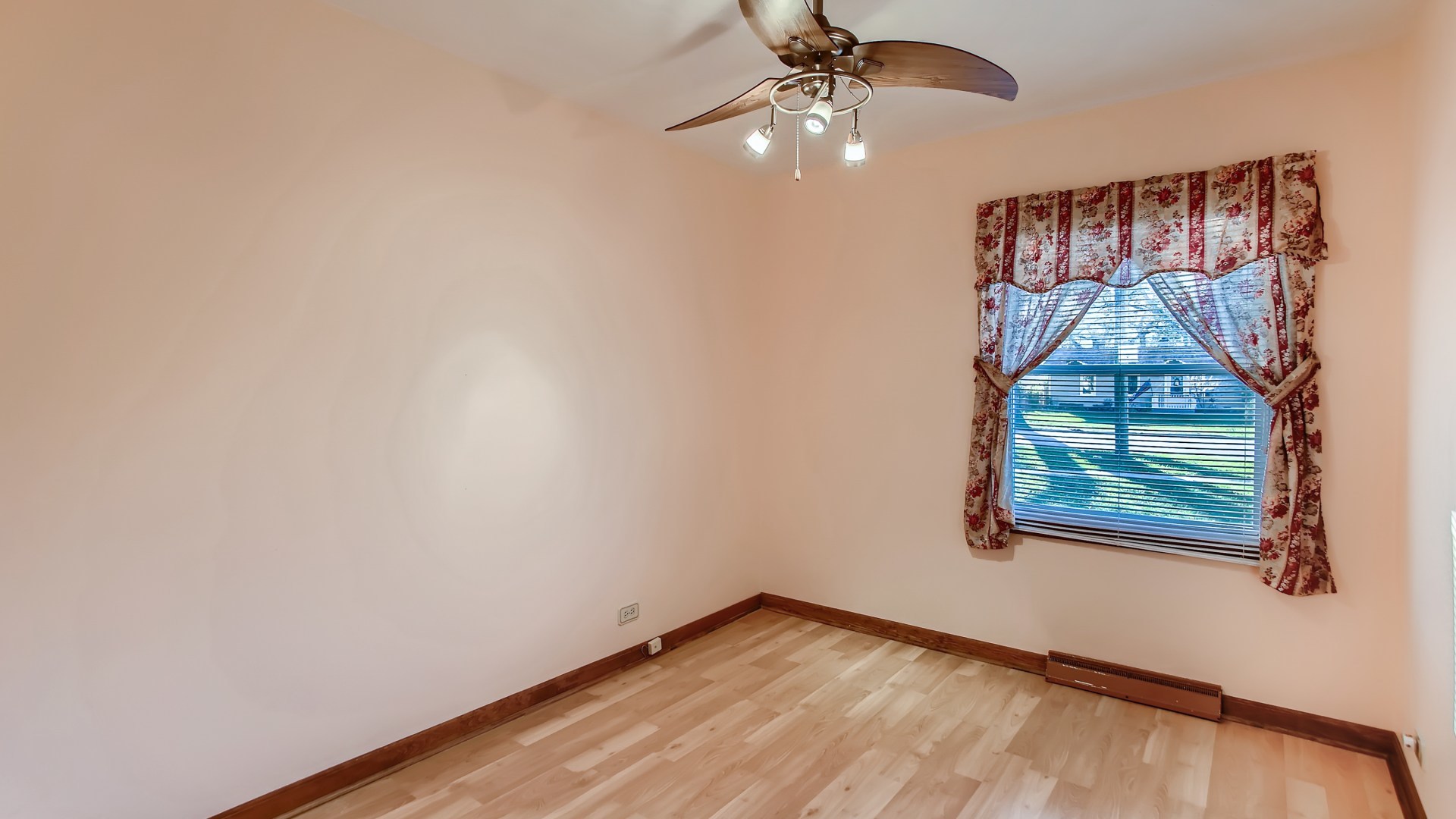 171 Raupp Boulevard Buffalo Grove, IL 60089 - Photo 15 of 23 an empty room with wooden floor chandelier fan and windows