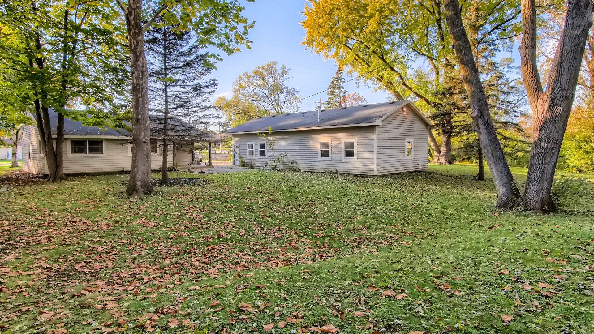 171 Raupp Boulevard Buffalo Grove, IL 60089 - Photo 23 of 23 front view of a house with a large tree and a yard