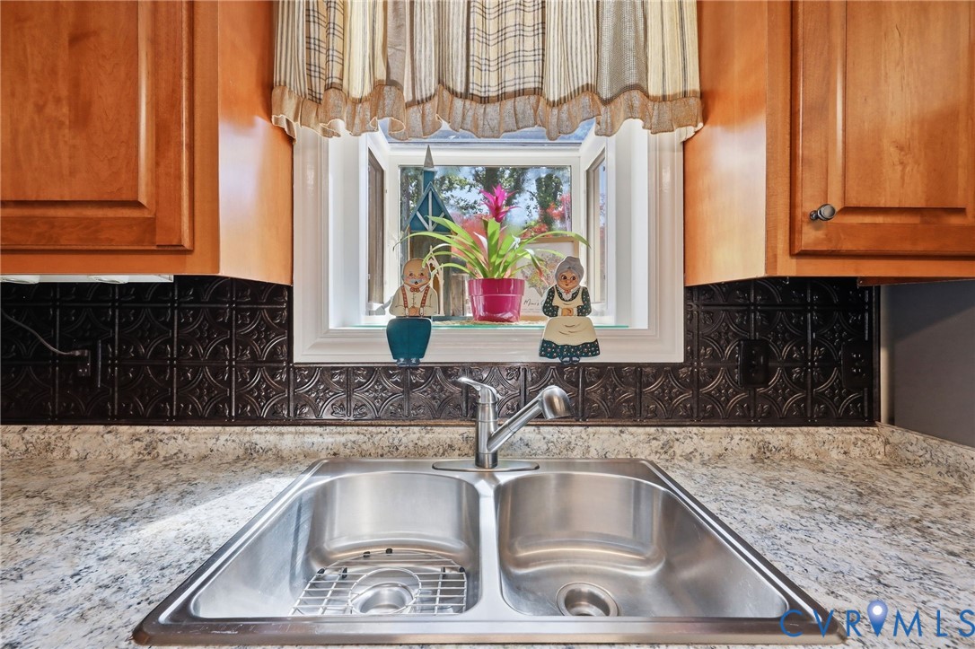11200 Surry Road Chester, VA 23831 - Photo 18 of 48 a kitchen with kitchen island a sink and a window