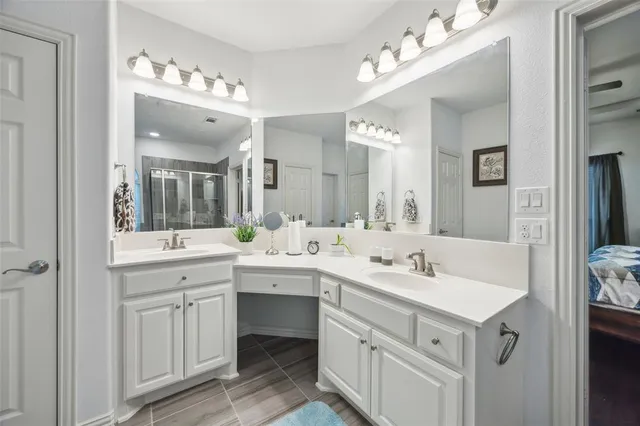 a spacious bathroom with a sink double vanity and a mirror
