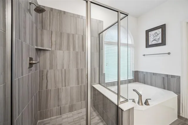 a bathroom with a tub and shower