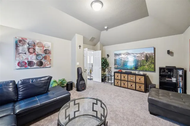 a living room with furniture gym equipment and a large window