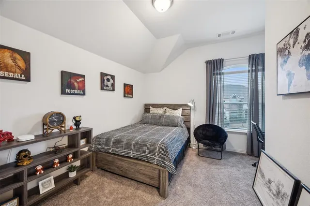 a bedroom with a bed and a couch