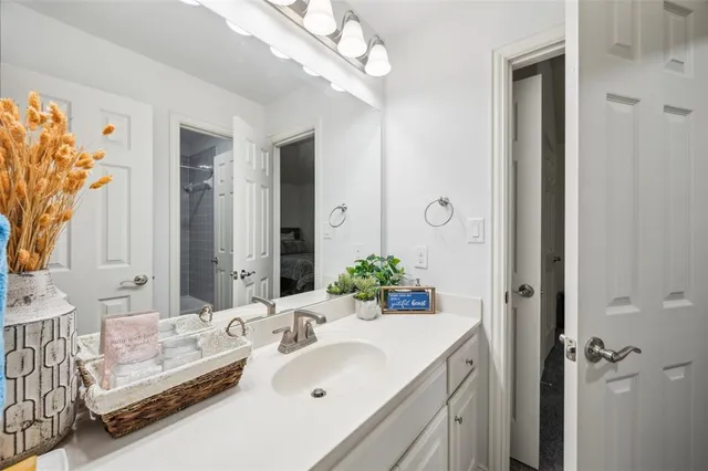 a bathroom with a sink double vanity and a mirror
