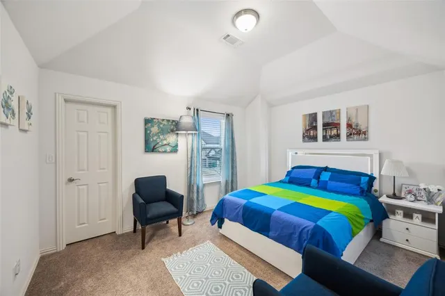 a bedroom with a bed and a chair