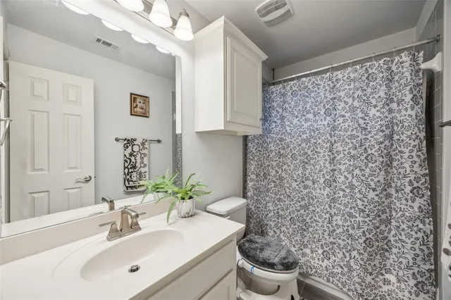 a bathroom with a sink toilet and mirror