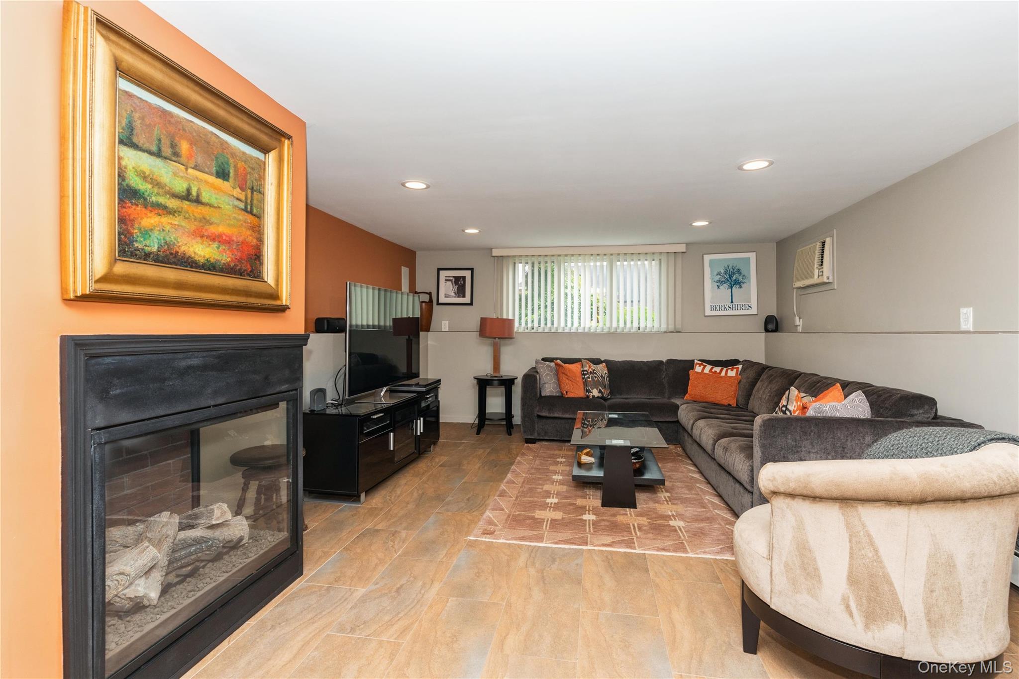 2772 Riverside Avenue Merrick, NY 11566 - Photo 18 of 45 a living room with furniture and a fireplace