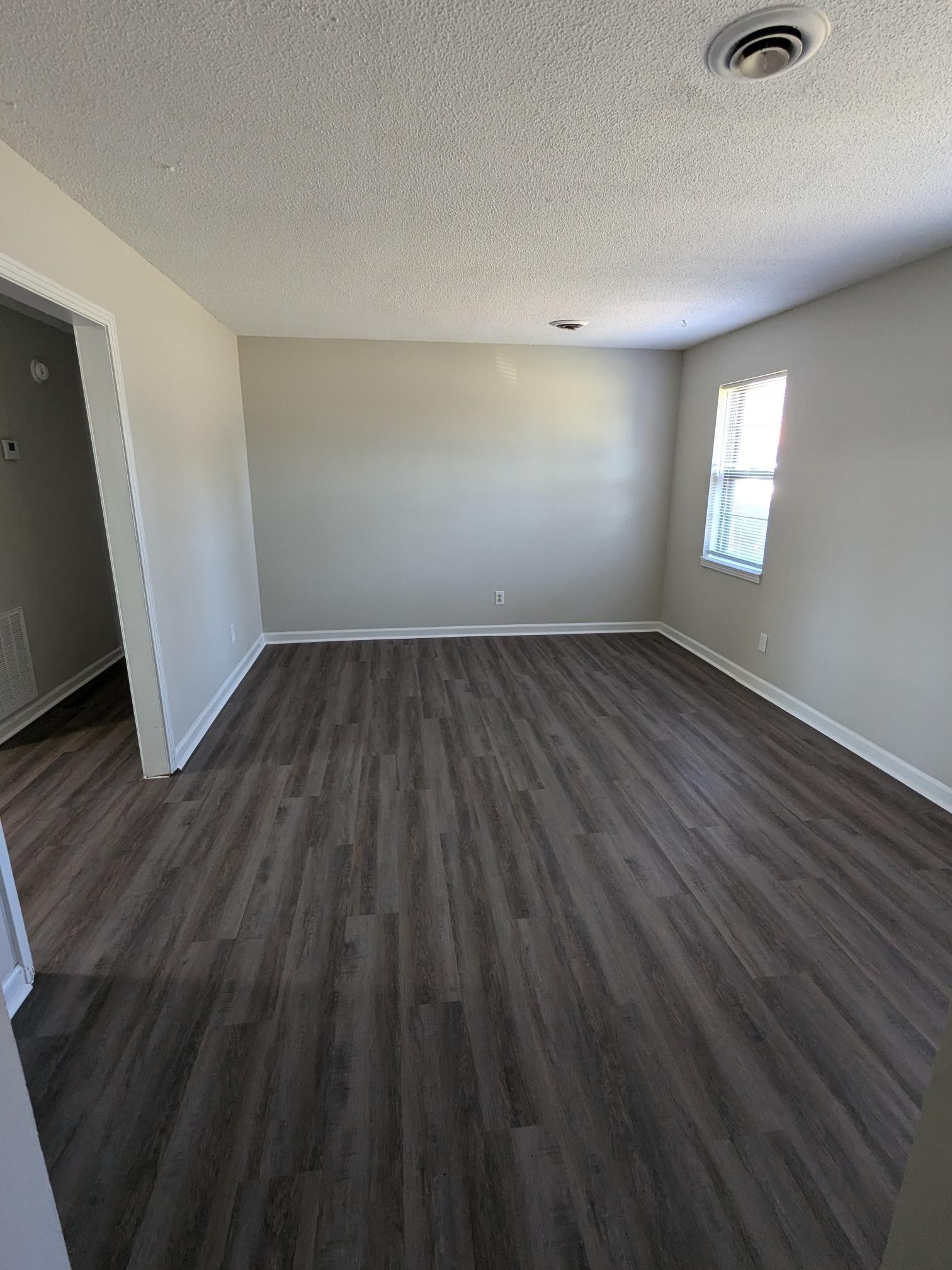 413 Shawnee Drive Columbia, TN 38401 - Photo 5 of 11 an empty room with wooden floor and windows