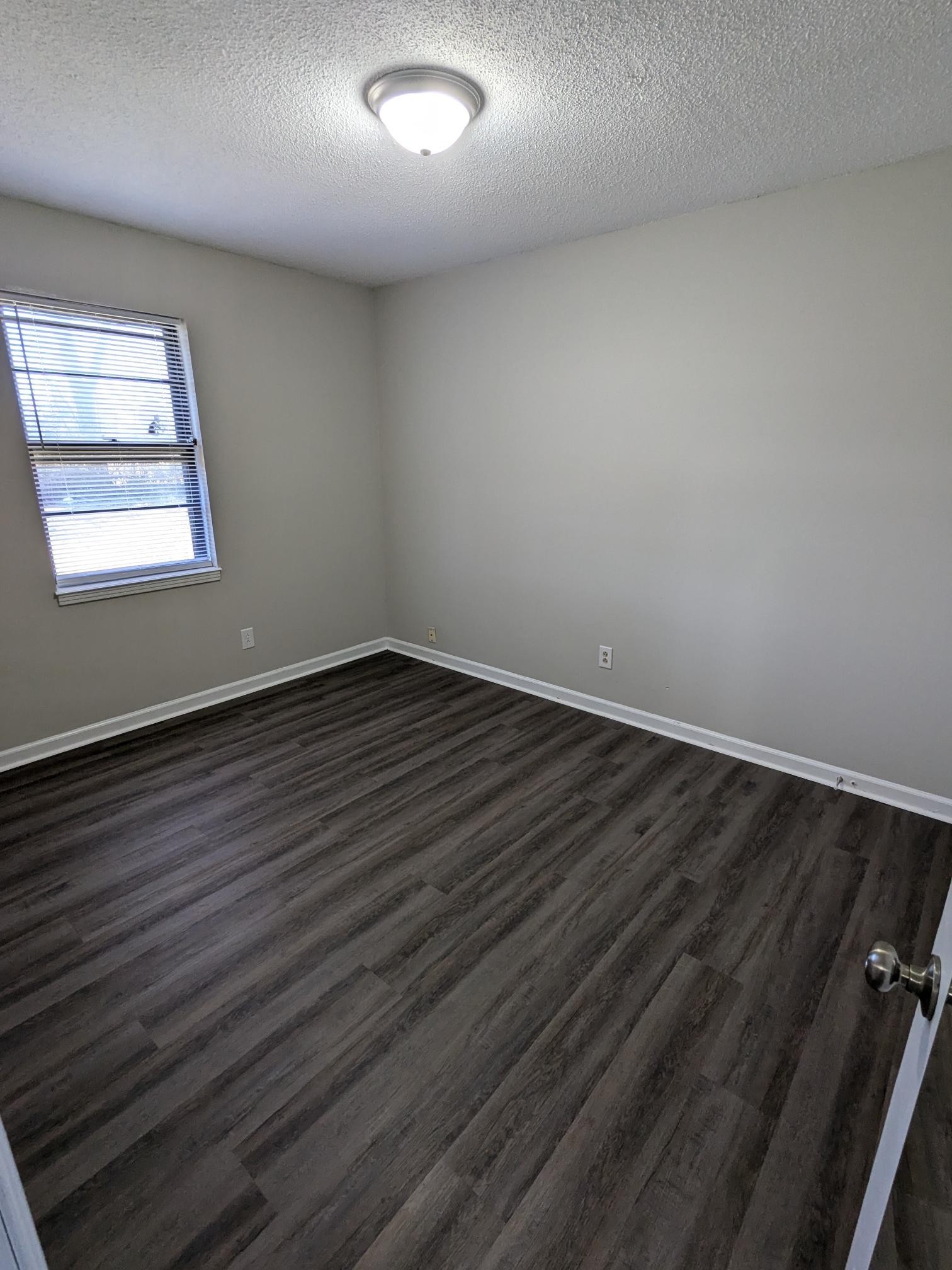 413 Shawnee Drive Columbia, TN 38401 - Photo 6 of 11 an empty room with wooden floor and windows