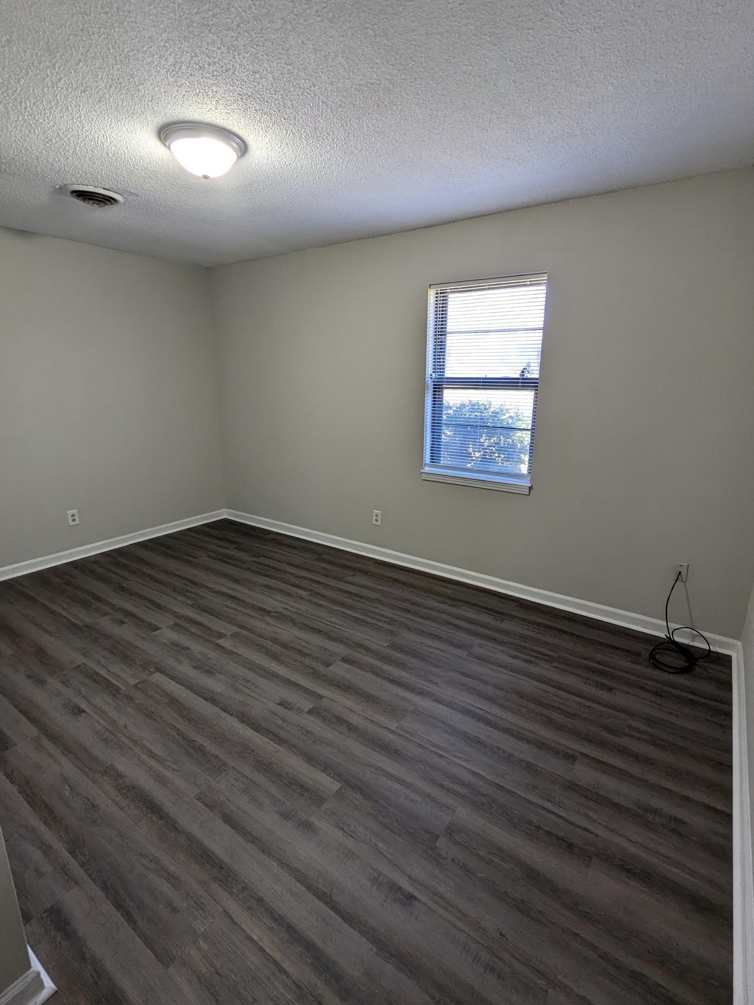 413 Shawnee Drive Columbia, TN 38401 - Photo 7 of 11 an empty room with wooden floor and windows