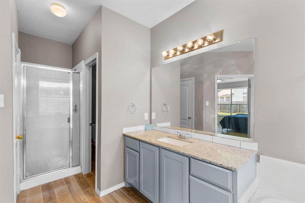 2700 Hereford Road Denton, TX 76210 - Photo 18 of 36 Bathroom featuring wood-look tile flooring and light gray walls