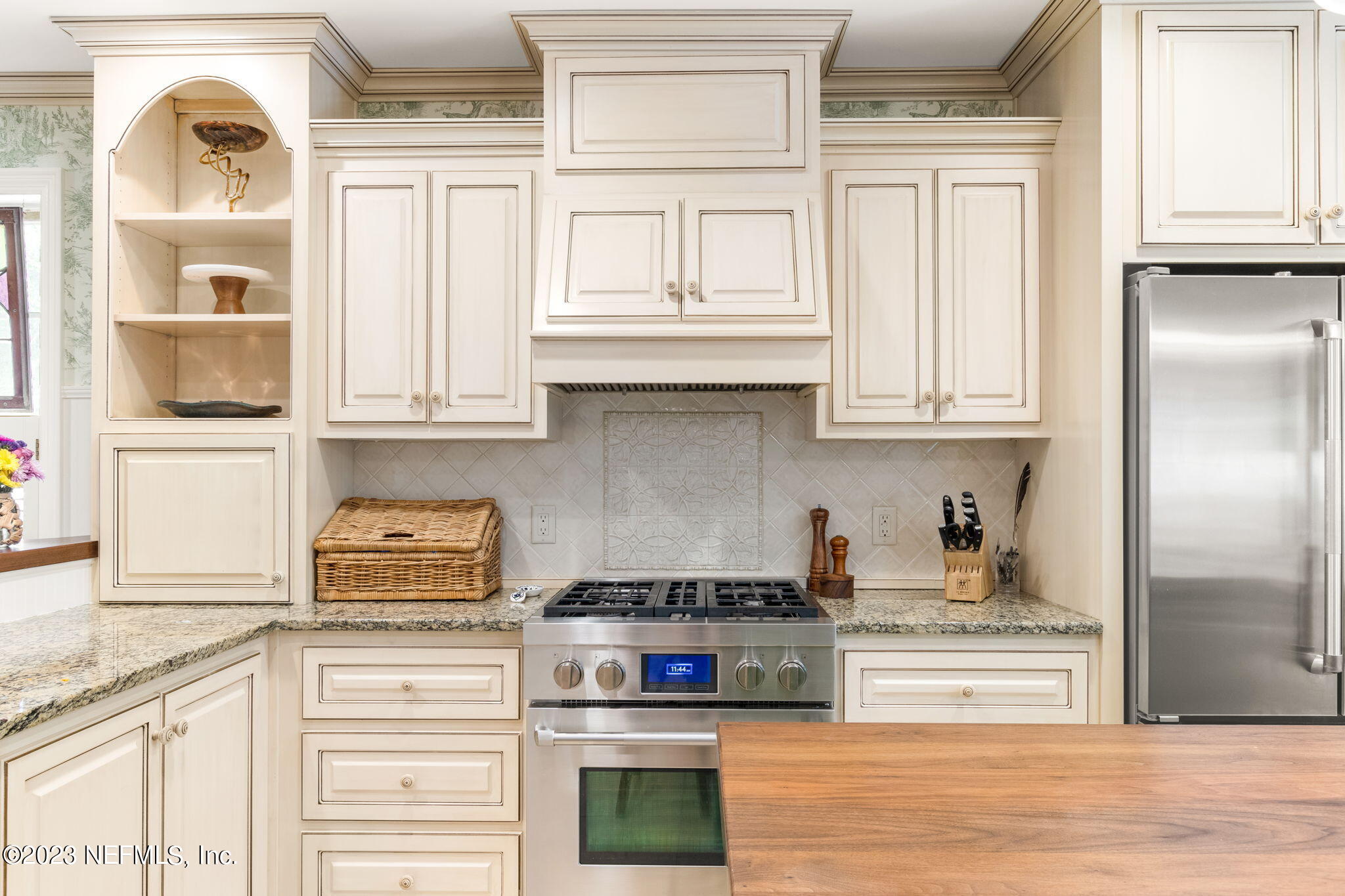 9465 Kells Road Jacksonville, FL 32257 - Photo 24 of 63 a kitchen with stainless steel appliances granite countertop a stove and a cabinets