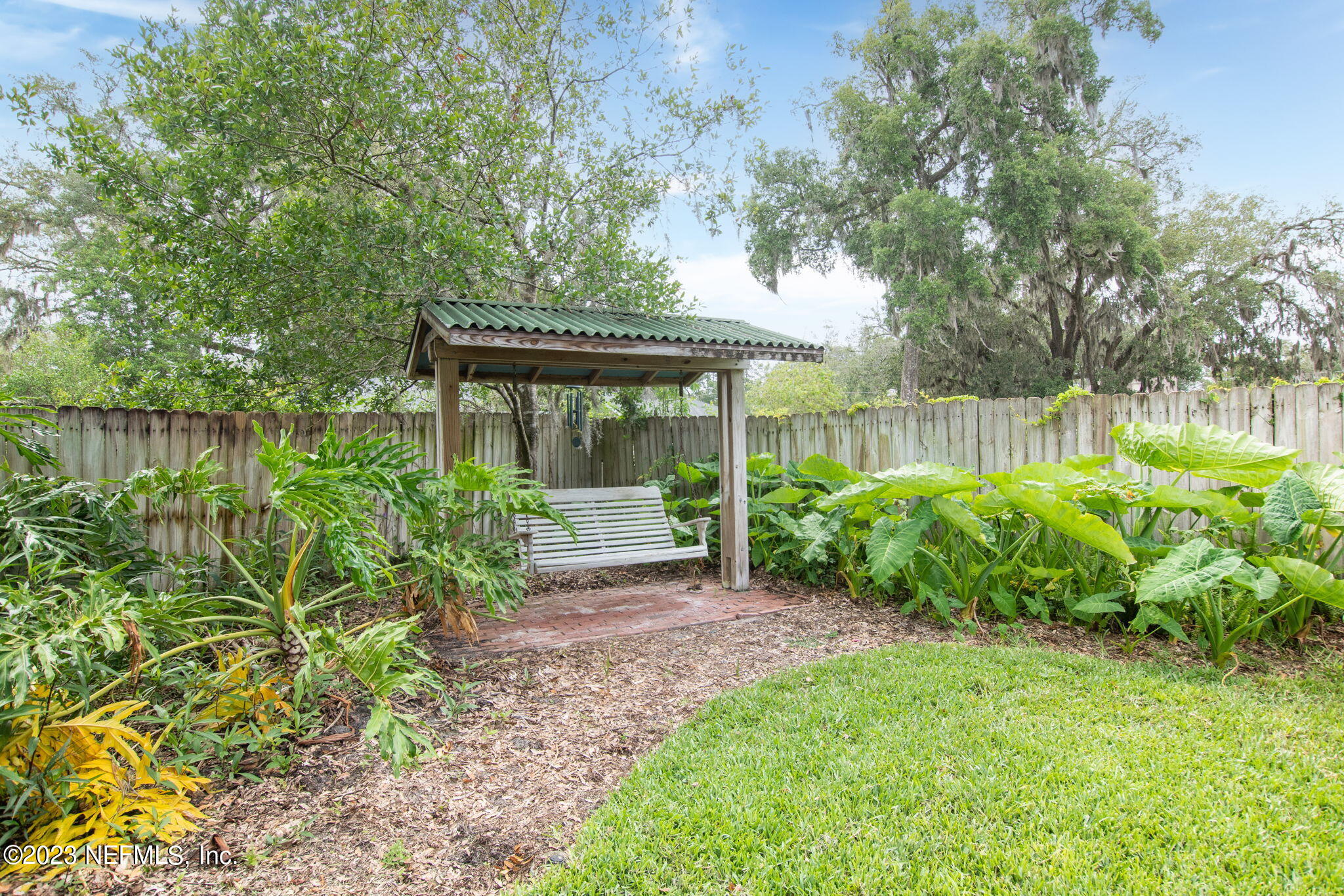 9465 Kells Road Jacksonville, FL 32257 - Photo 54 of 63 a view of a garden with a bench in a garden