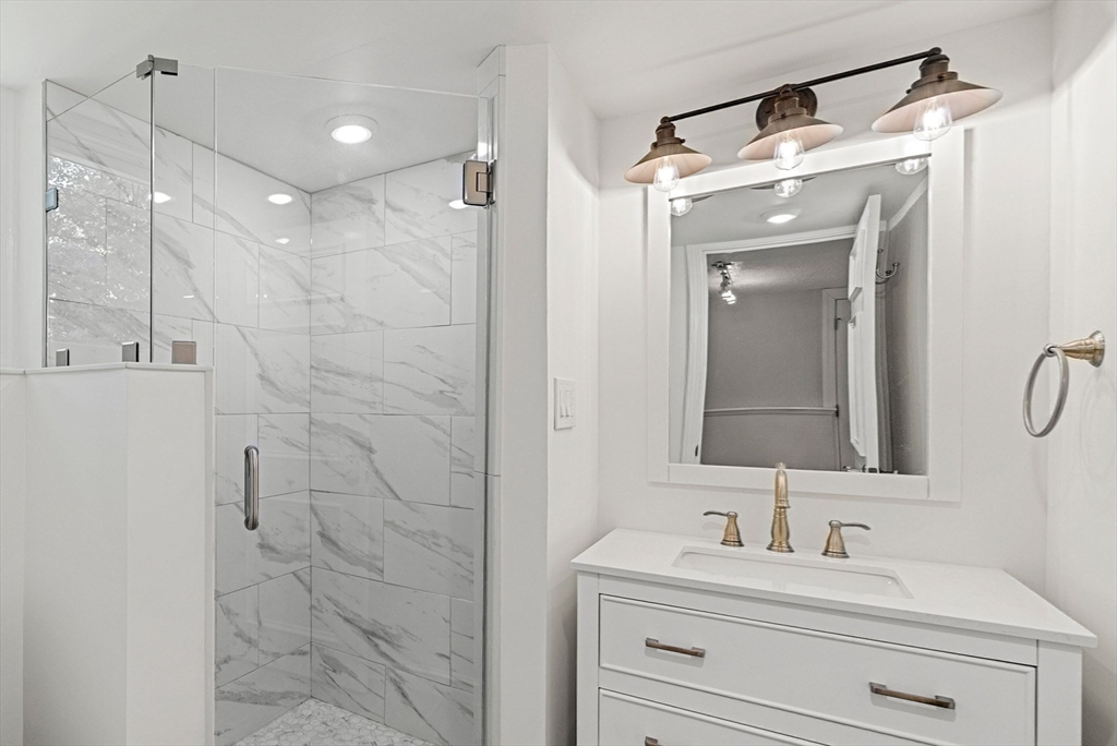 53 Windsor Road Wellesley, MA 02481 - Photo 35 of 42 a bathroom with a sink and a mirror