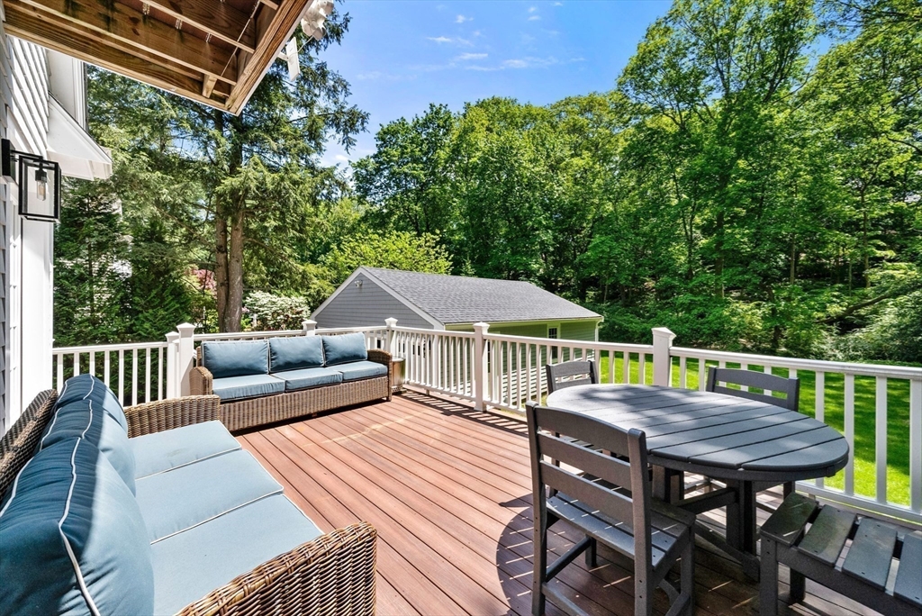 53 Windsor Road Wellesley, MA 02481 - Photo 37 of 42 a view of a patio with a table chairs and a deck