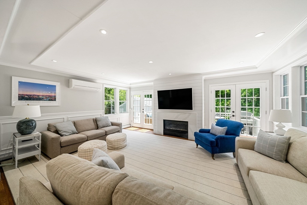 53 Windsor Road Wellesley, MA 02481 - Photo 8 of 42 a living room with furniture a flat screen tv and a fireplace