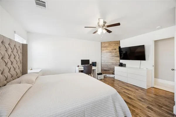 a bedroom with a bed and a flat screen tv