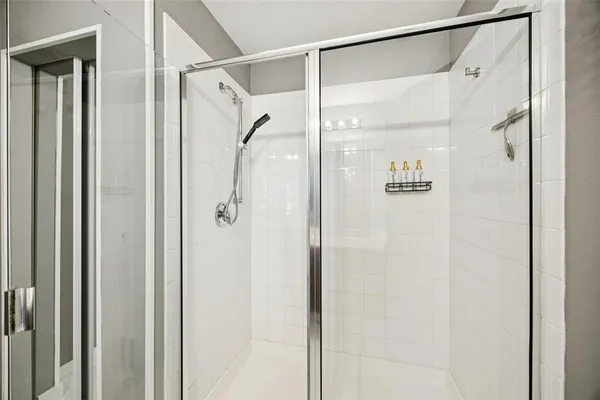 a bathroom with a glass shower door