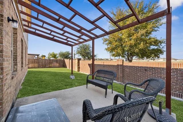a view of a patio with a table chairs and a backyard