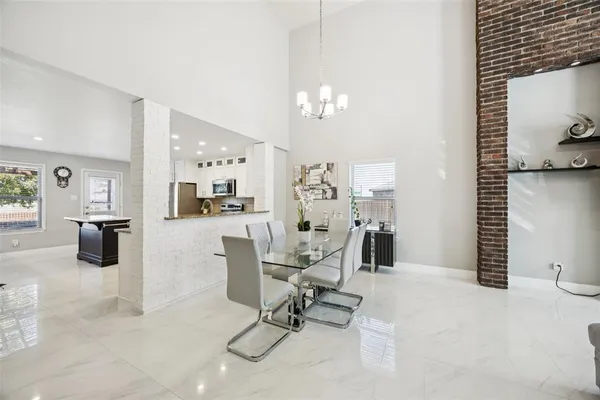 a work room with furniture and view of kitchen