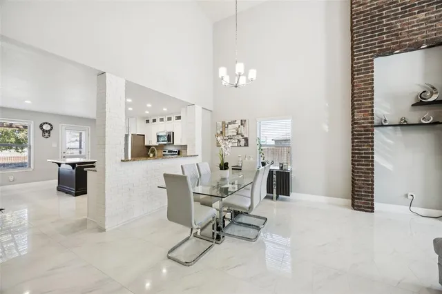 a work room with furniture and view of kitchen