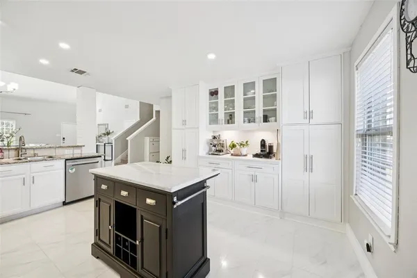 a kitchen with a stove a sink dishwasher and a refrigerator