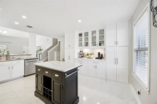 a kitchen with a stove a sink dishwasher and a refrigerator