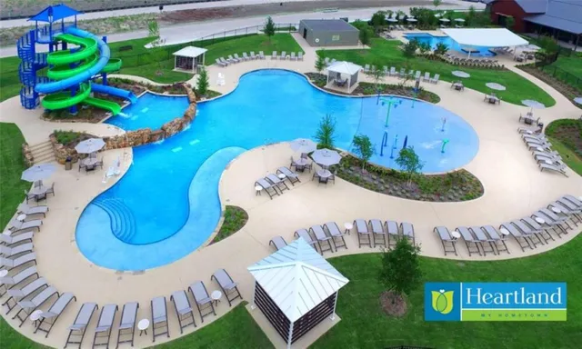 a view of a swimming pool with a yard and outdoor seating