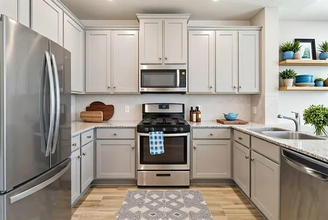 a kitchen with a refrigerator stove and sink