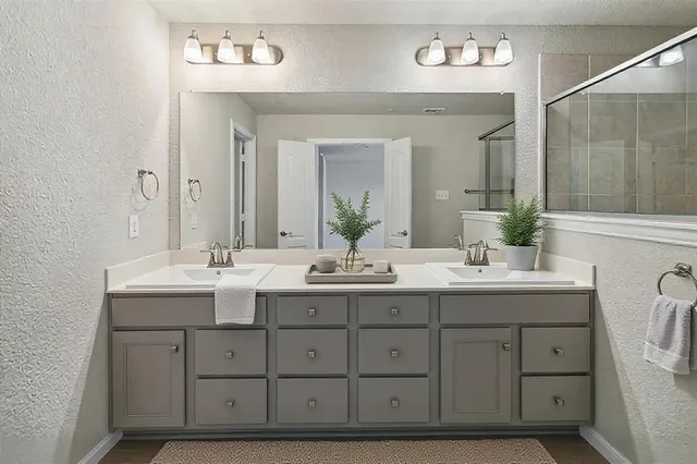 a bathroom with a double vanity sink and a mirror