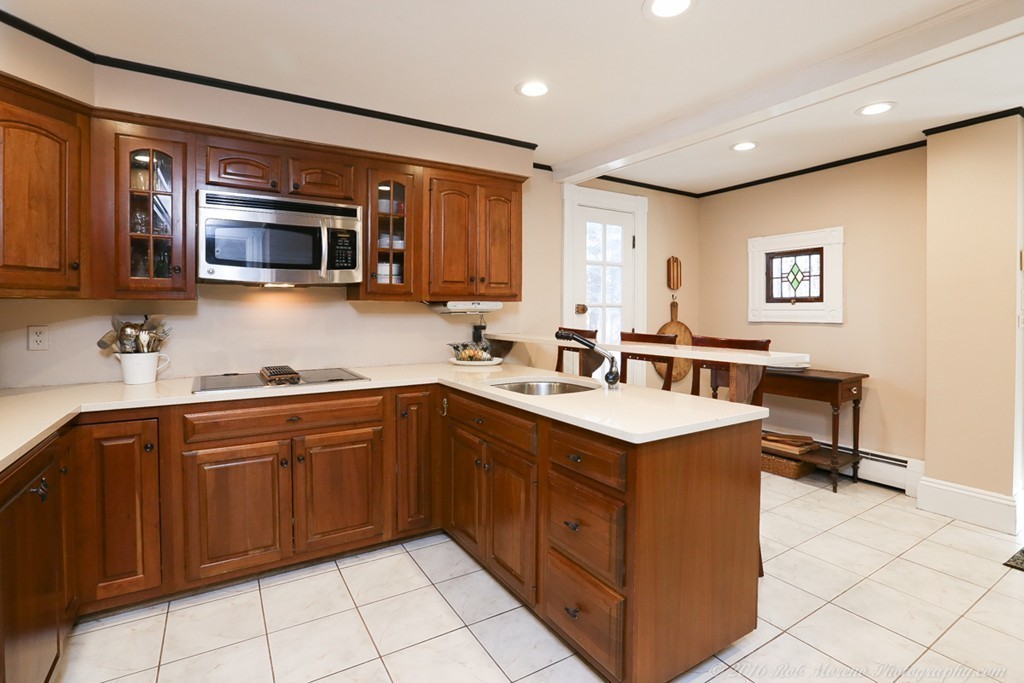 9 Woodside Road Topsfield, MA 01983 - Photo 4 of 27 a kitchen with a stove sink and microwave